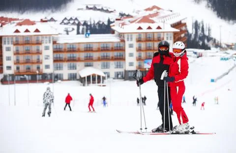 Young couple standing on a ski slope Stock Photos