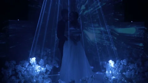 A young couple stands in a circle of laser projection, on their background a 스톡 동영상 150381304
