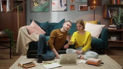 Young Couple staying at home, using laptop computer together, woman holding Stock Footage 158234219
