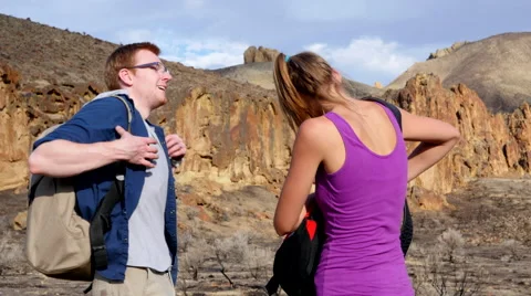 Young couple stops for snack during hike Stock Footage 67299497