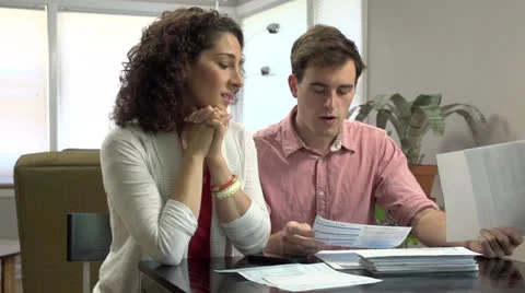 Young couple stressed out over bills Stock Footage 24756196