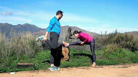 Young couple stretching after jogging on the mountains, 4K Видео 61866479