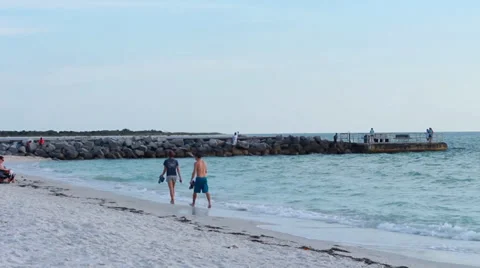 Young couple strolling along the beach Stock Footage 38257155