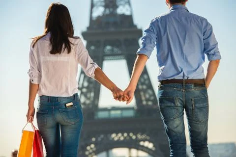 Young couple strolling in front of  Eiffel Tower, Paris, France Fotos Stock