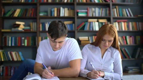 Young couple of students preparing to the exam. people, knowledge, education and Stock Footage 86183460