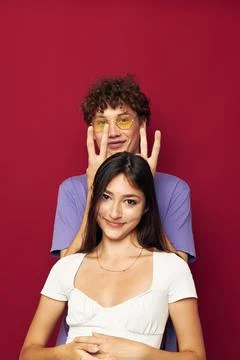 A young couple summer style posing fashion emotions red background Stock Photos