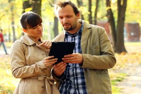 Young couple with tablet computer in autumn park Stock Footage 8950682