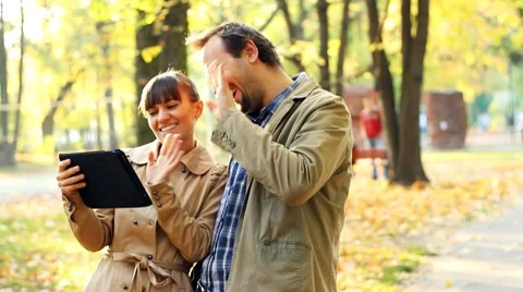 Young couple with tablet computer in autumn park Video stock 8950705
