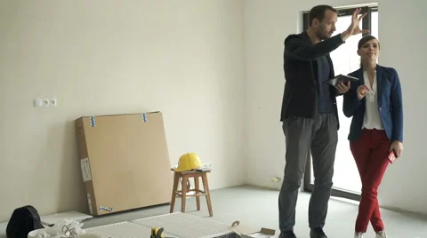 Young couple with tablet computer talking about new home project Video stock 63507593