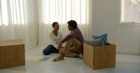 Young couple taking a break while moving house. Stock Footage 88373834