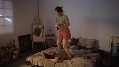 Young Couple Taking Pictures with Compact Camera in Bedroom Stock Footage 345219801