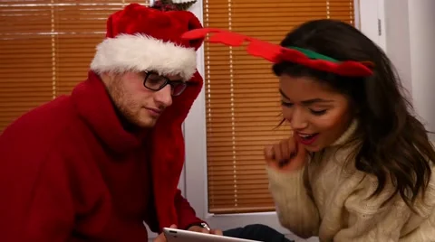 Young couple taking pictures using tablet pc. Christmas time. 50 fps. Stock Footage 57369365