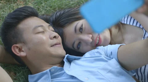 Young couple taking self-portrait Stock Footage 30427631