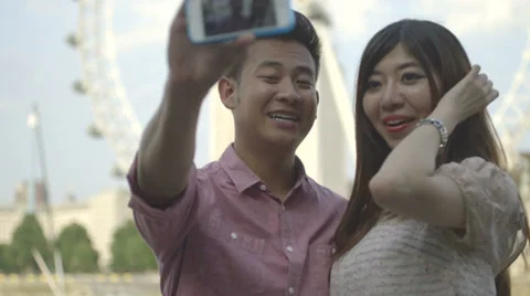 Young couple taking self-portrait Stock Footage 30429324