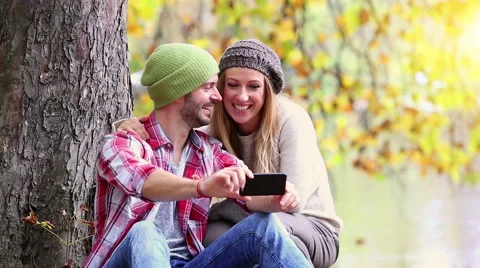 Young couple taking selfie in forest Video stock 57376967