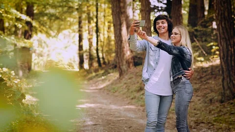 Young Couple Taking Selfie On A Forest Walking Video stock 89893934