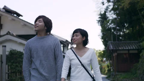 Young couple taking a stroll in a quiet area of Kyoto, Japan with soft natural l Stock Footage 199461435