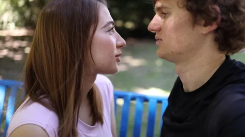Young couple talk face to face as romantic attraction grows during outdoor date Stock Footage 342267935