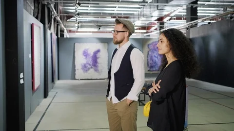 Young couple talking about the work of modern artist Stock Footage 118545252