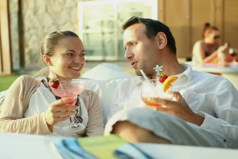 Young couple talking and drinking exotic cocktails NTSC Stock Footage 10901722