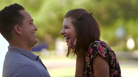 Young couple talking and smiling outside Stock-Footage 64337542