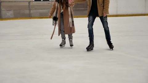 Young couple talking and smiling on a ski rink Stock-Footage 129679931
