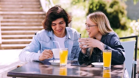 Young couple talking and spending time together while drinking coffee Stock Footage 89825250