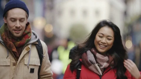 Young couple talking and walking in the street Stock Footage 84675437