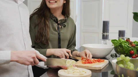 Young couple talking and working in the kitchen Stock Footage 99941749