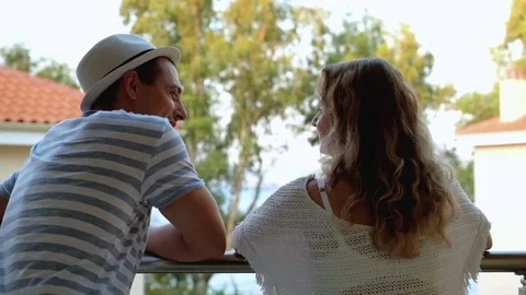 Young couple talking on balcony Stock Footage 72484885