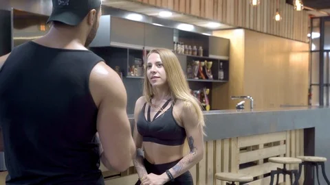 Young couple talking in a bar after a workout in the gym. Stock Footage 109122330