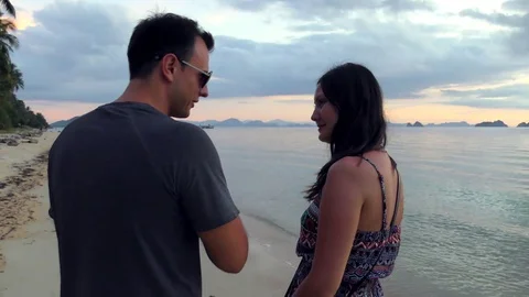 Young couple talking on the beach Stock Footage 83114126