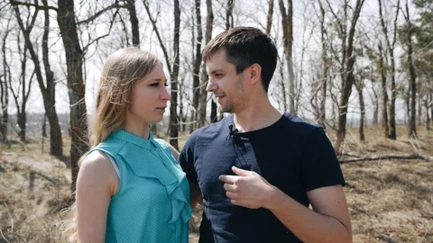 Young couple talking to camera in forest. Interview 動画素材 94873685