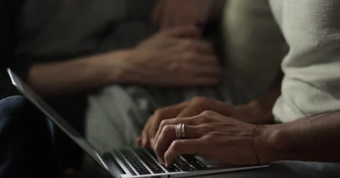 Young couple talking to each other while using laptop Stock Footage 63374104
