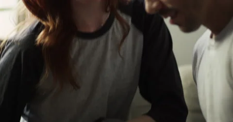 Young couple talking to each other while using laptop Vídeo Stock 63374116