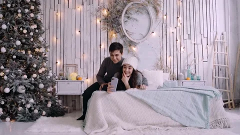 Young couple talking to friends using a phone because of the Covid 19. Stock Footage 143750384