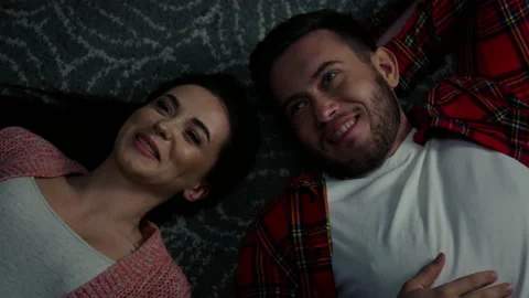 Young Couple Is Talking Lying on Carpet Stock Footage 144737387