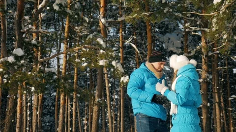 Young couple talking at mobile phone in winter forest Stock Footage 86571072