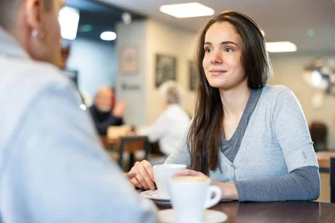 Young couple talking over a cup of coffee in a cozy cafe Fotos Stock