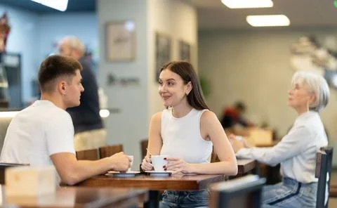 Young couple talking over a cup of coffee in a cozy cafe Fotos Stock