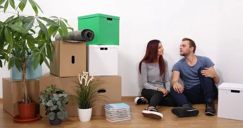Young Couple Talking Positive Planning Cheerful Communication in a New Apartment Stock Footage 70227777