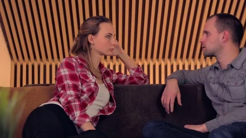 Young couple talking on the Sofa Stock Footage 72480562