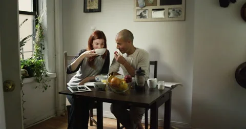 Young couple talking while having breakfast at home Vídeo Stock 63374739