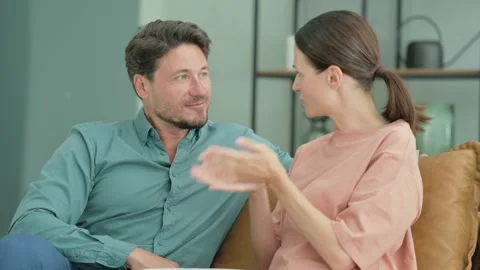 Young Couple Talking while Relaxing at Home Видео 287412171