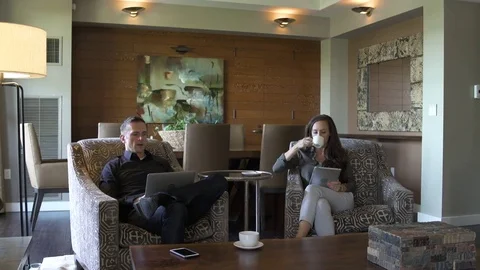 Young couple talking while sitting in a suite 스톡 동영상 83392535