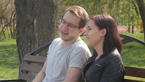 Young couple talking while sitting on the bench 스톡 동영상 90777468