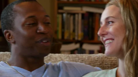 Young couple talks and laughs on couch, close up Stock Footage 53013832