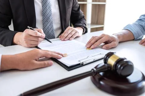 Young couple telling their problems in the courthouse to getting divorced or Stock Photos