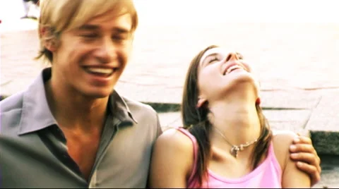 Young Couple in Town sitting on steps Stock Footage 43685438