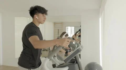 Young couple training in the gym while listening to music. Video stock 244739839